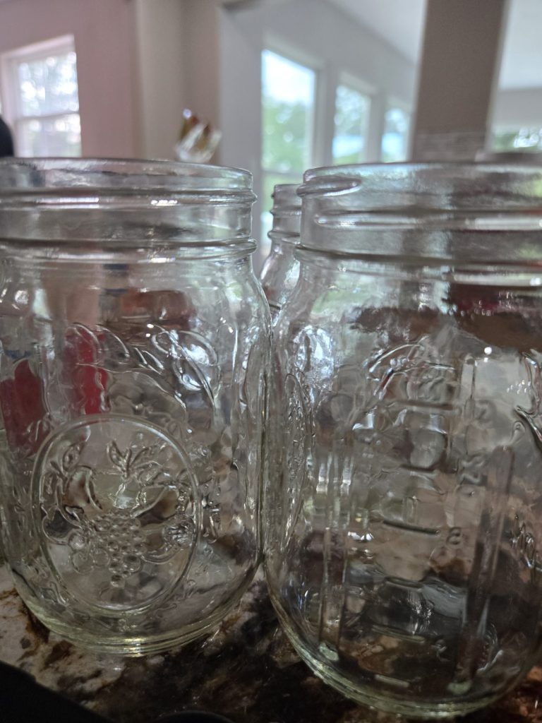 Clean empty pint jars ready for clam chowder base