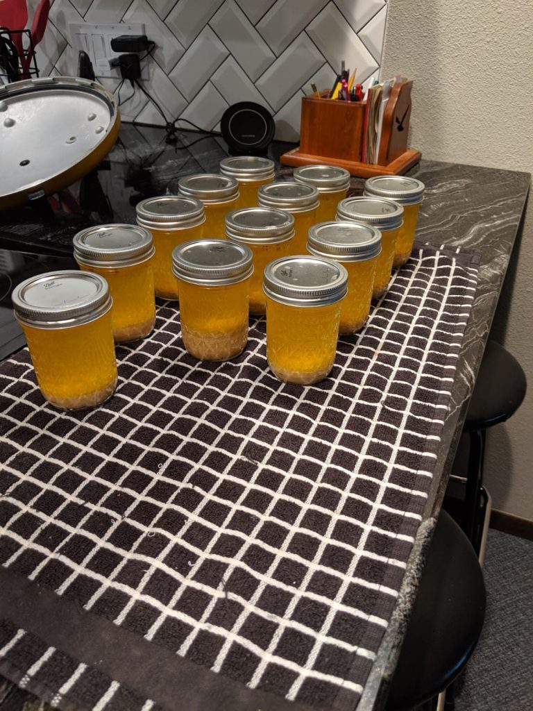 Jars of canned butter cooling on a towel