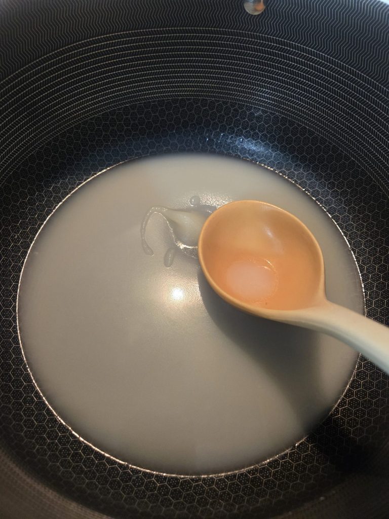 Ladling melted tallow out of a pot