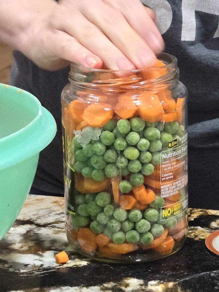 Jar layered with carrots and peas