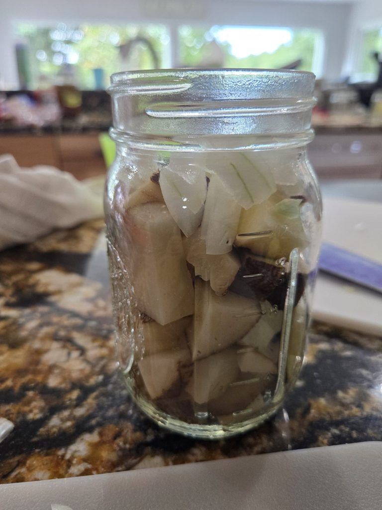 Pint jar filled with cubed potatoes and onions